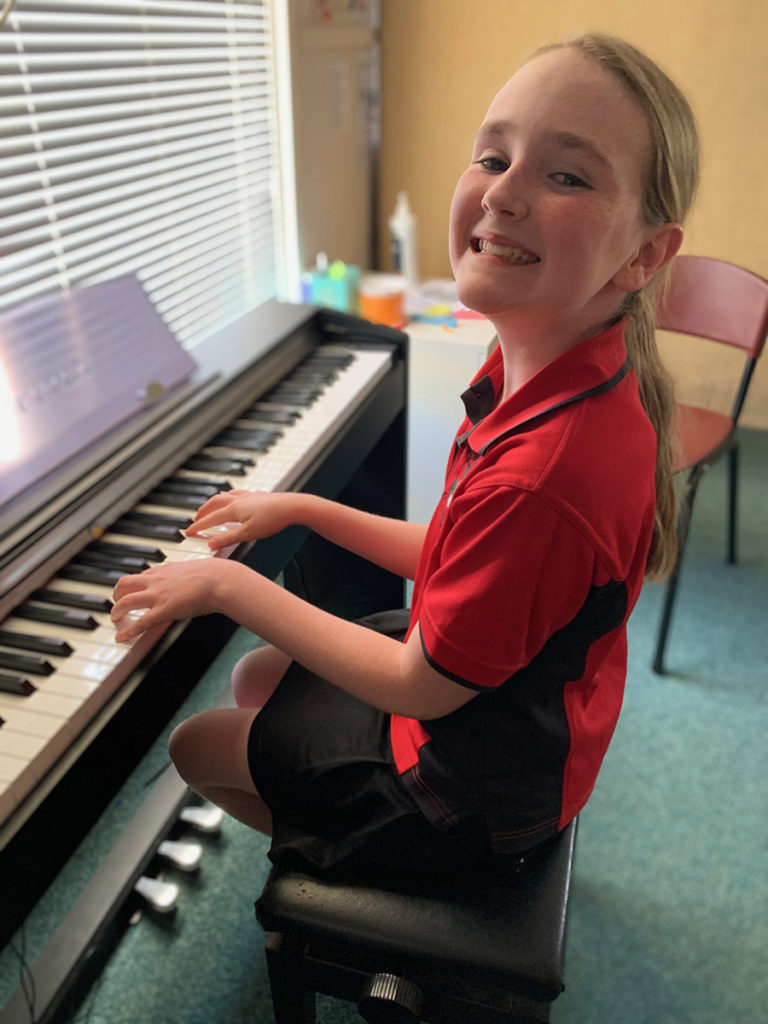 Girl playing piano during lesson with Mrs Munns Music Lessons in Bencubbin